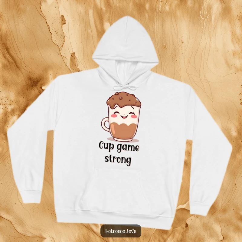 Funny grinning hot chocolate mug posing for a camera graphic on a cozy hoodie, a humorous and warm gift.